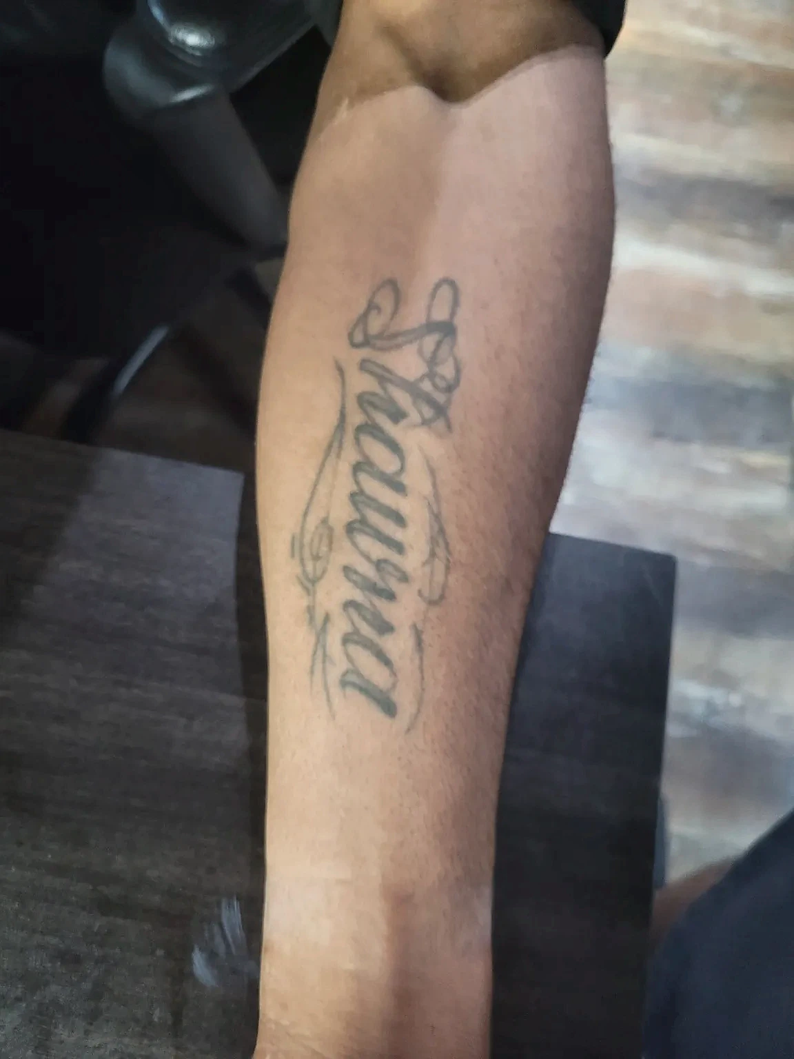 Existing script tattoo before cover-up